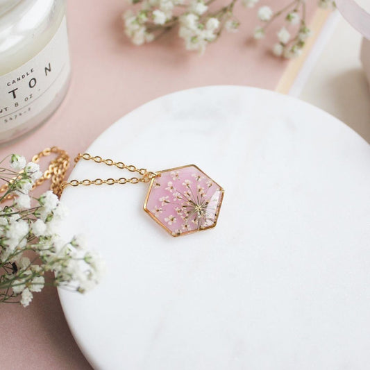 Hexagon Resin Necklace with White Dried Flowers on Pink Background